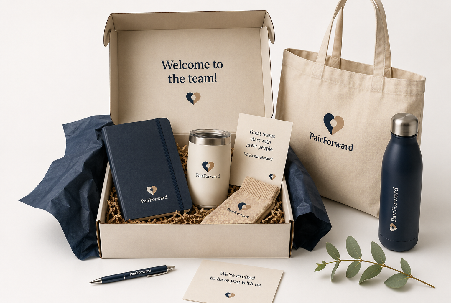 PairForward branded employee welcome kit with notebook, tumbler, socks, tote and bottle