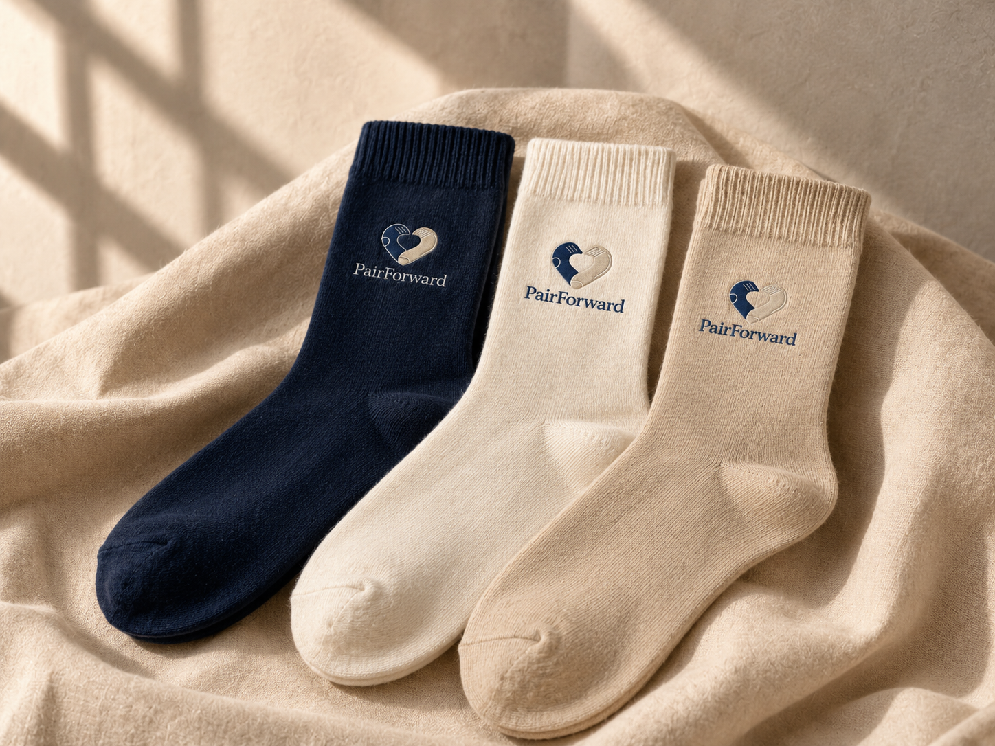Stack of custom branded corporate socks in navy, white, beige and black